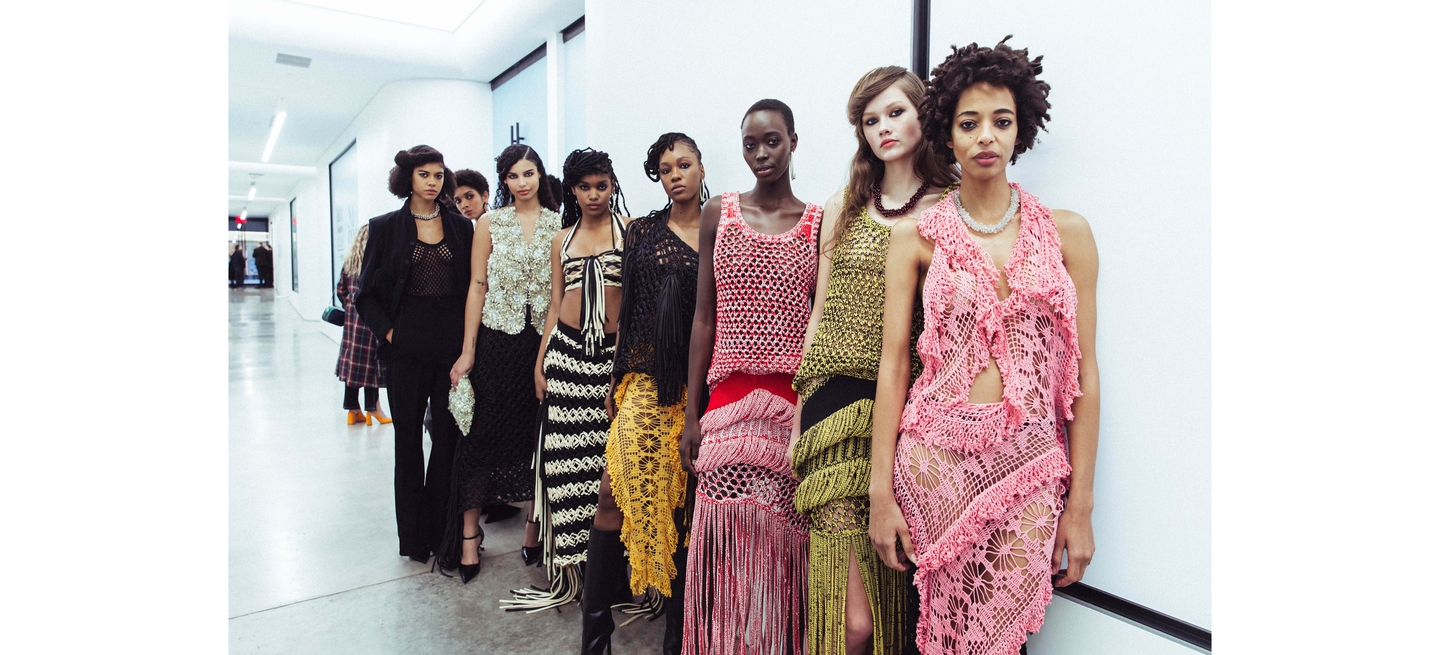Group of models in crochet and embellished outfits backstage at NYFW F/W 2024.